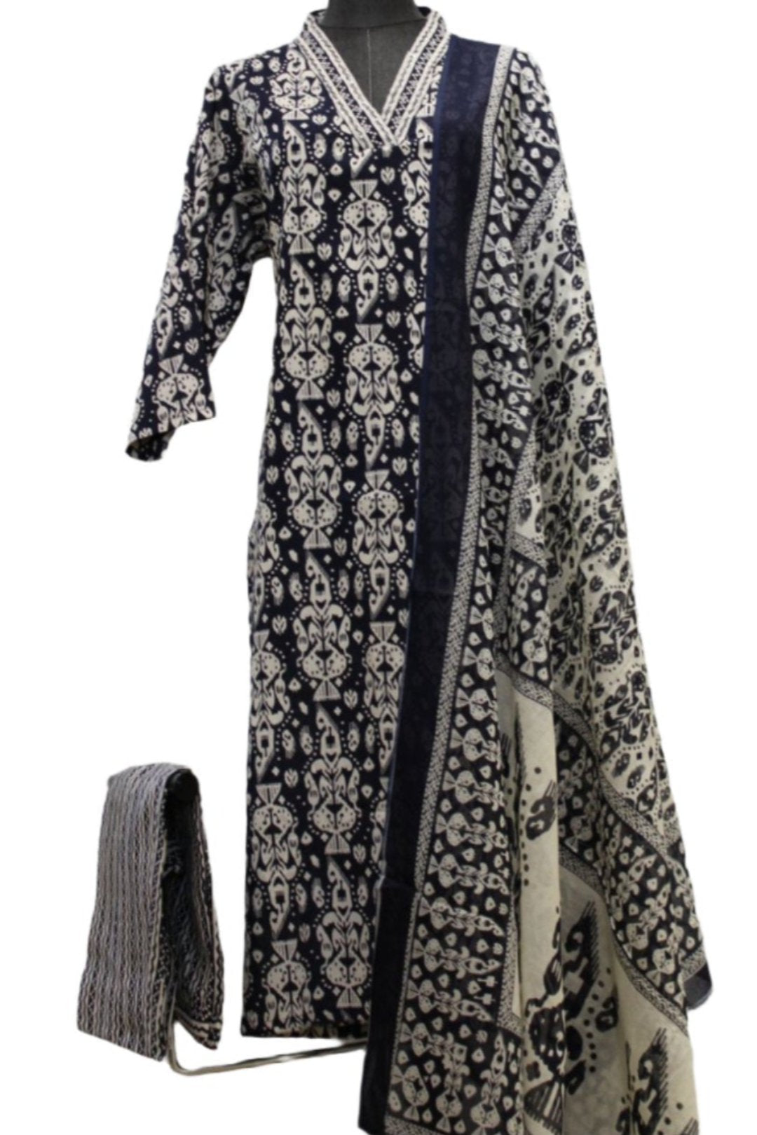 Cotton salwar kameez with dupatta containing patterns. The kurti has a straight cut design adorned with large flowers and round neckline.