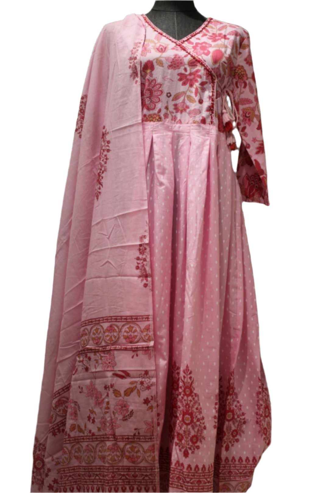 Vibrant pink salwar kameez with white polka dots with red floral patterns on the kameez add a touch of elegance.