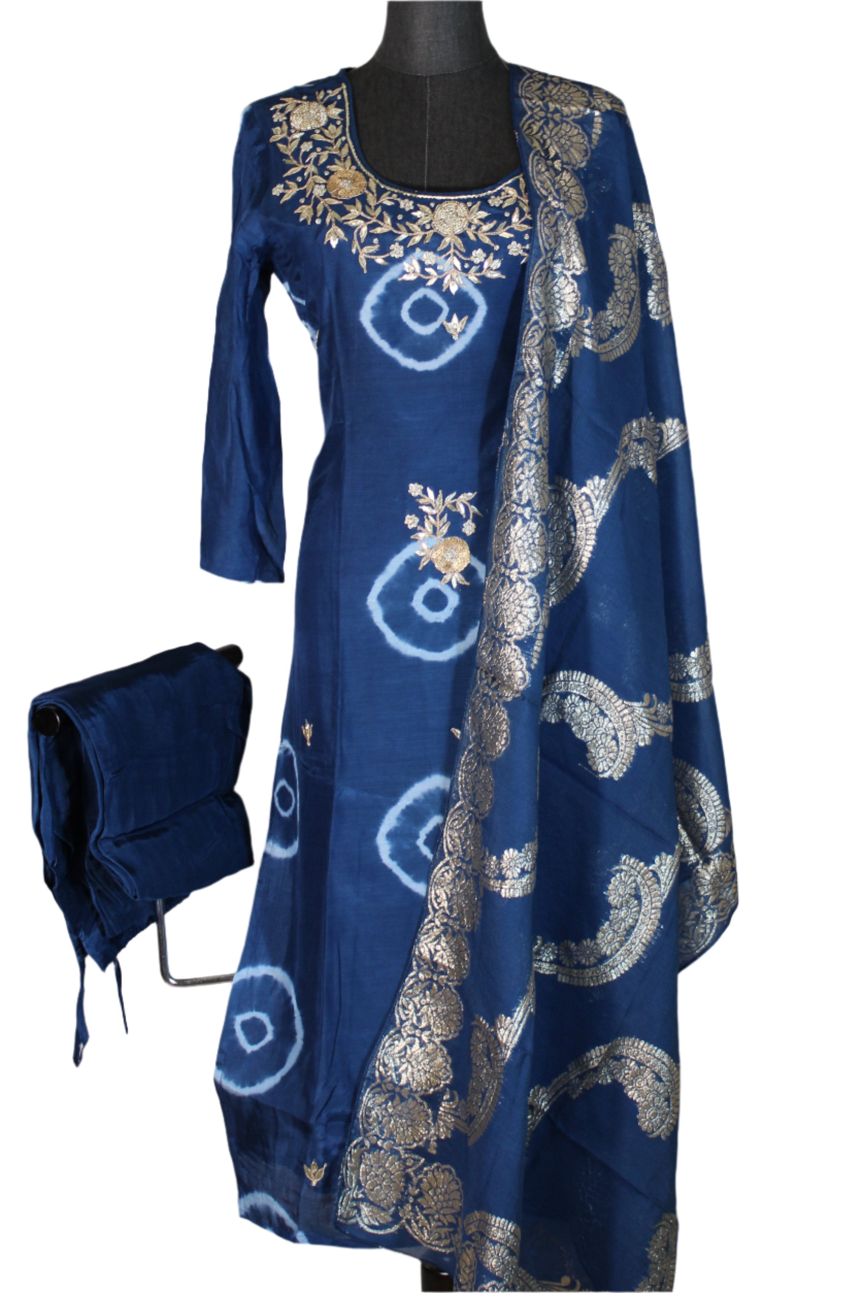 Long, blue ethnic or traditional style garment, salwar kameez, with intricate gold embroidery and patterns.