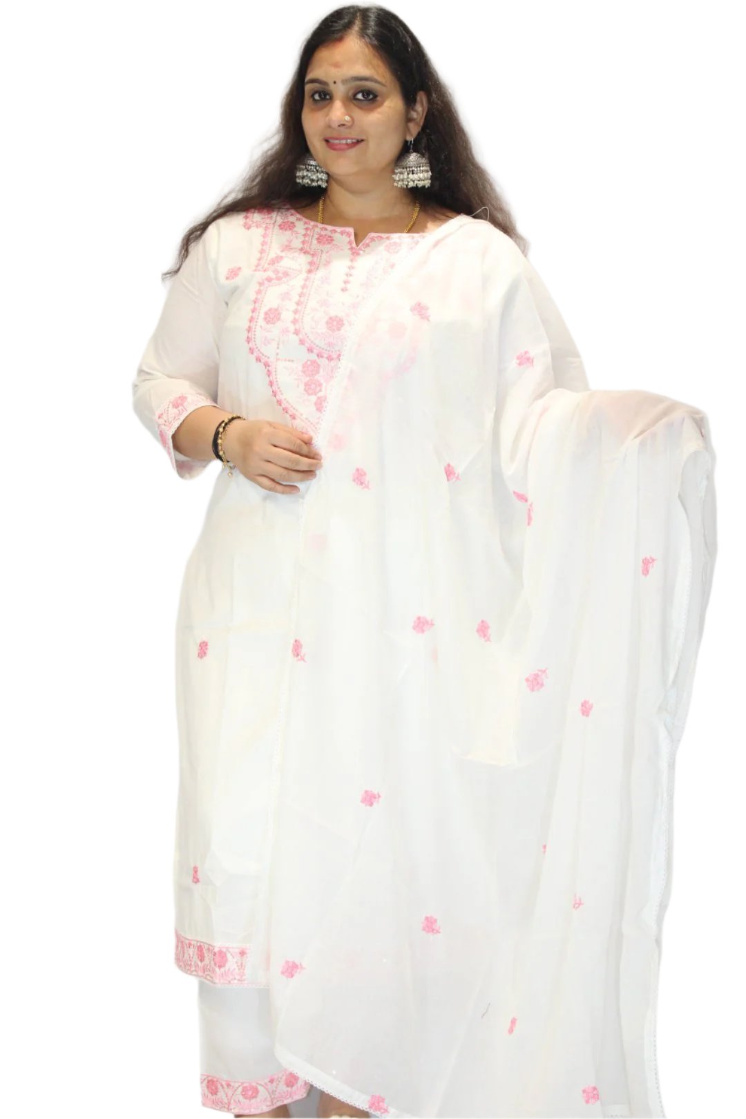 The dress is a white traditional garment adorned with intricate pink embroidery. It features detailed patterns around the neckline and throughout the fabric, showcasing skilled textile work.