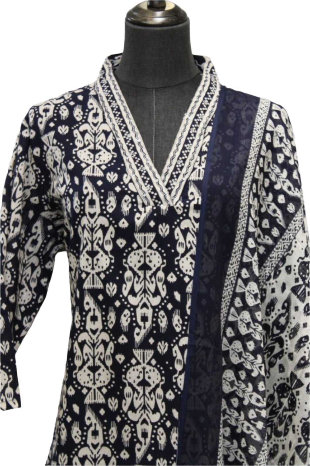 Cotton salwar kameez with dupatta containing patterns. The kurti has a straight cut design adorned with large flowers and round neckline.